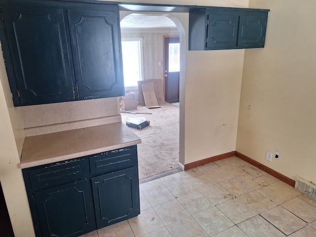 1471 Wadhams Rd, Kimball, MI 48074 - kitchen with arched walkways, light tile patterned floors, light countertops, baseboards, and visible vents