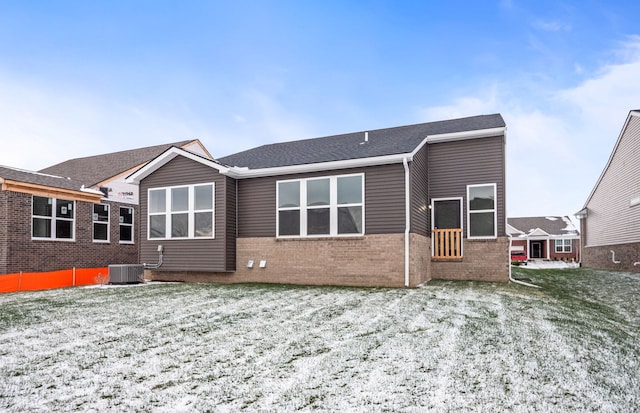 back of property featuring cooling unit and brick siding