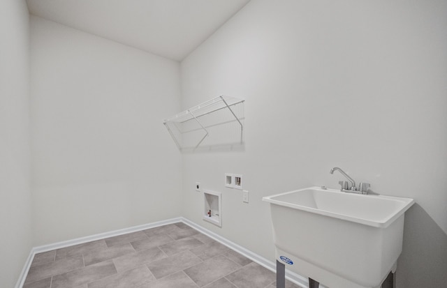 clothes washing area featuring laundry area, washer hookup, a sink, baseboards, and electric dryer hookup