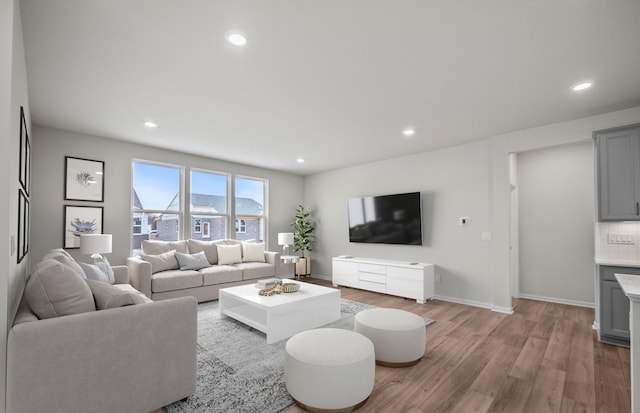 living room featuring recessed lighting, light wood-style flooring, and baseboards