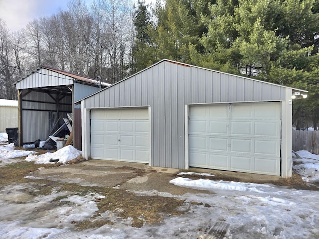 snow covered garage with a garage