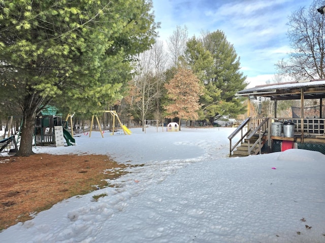 snowy yard featuring playground community