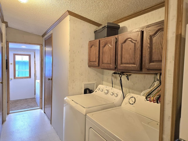 clothes washing area with cabinet space, wallpapered walls, a textured ceiling, light floors, and separate washer and dryer