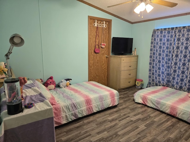 bedroom with a textured ceiling, ceiling fan, lofted ceiling, wood finished floors, and crown molding