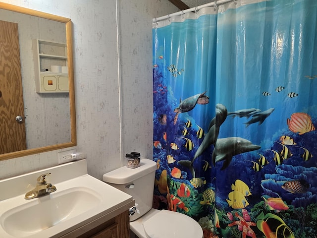 bathroom featuring toilet, wallpapered walls, a shower with shower curtain, and vanity