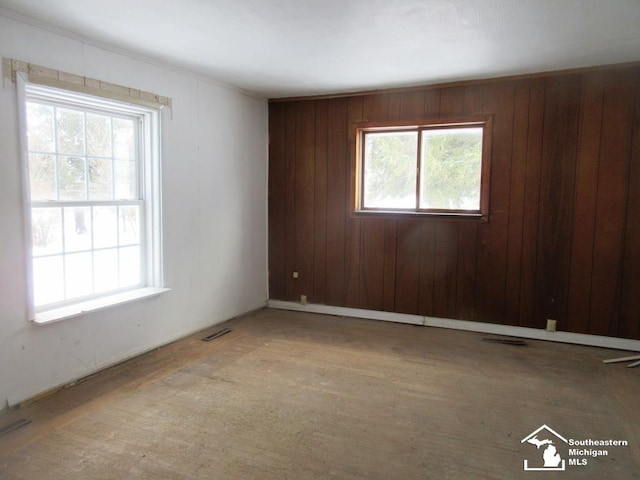 empty room featuring visible vents and a wealth of natural light