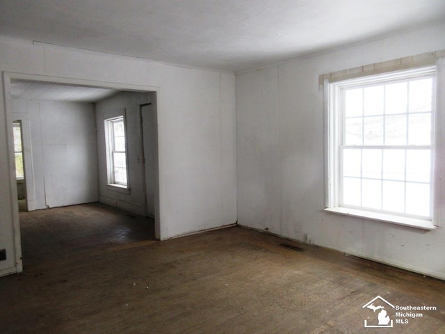 unfurnished room with wood finished floors