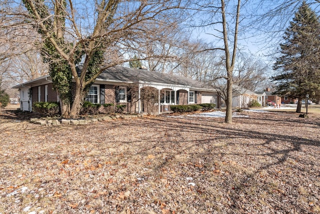 ranch-style house featuring brick siding