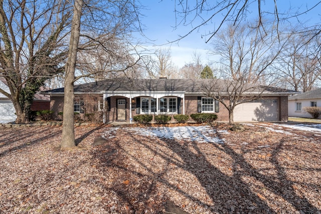 ranch-style home featuring an attached garage, dirt driveway, and brick siding