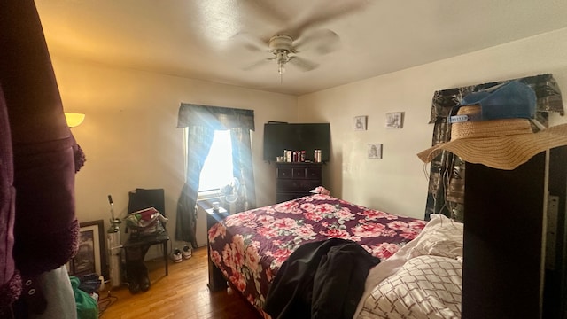 bedroom with a ceiling fan and wood finished floors