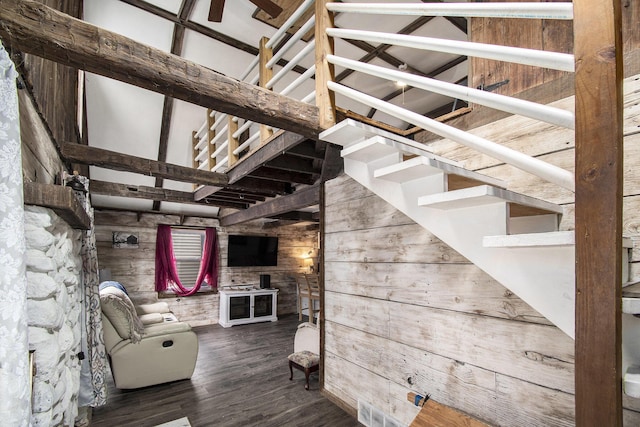 interior space featuring wood walls, stairs, visible vents, and wood finished floors