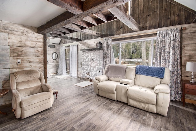 living area featuring wood walls, beamed ceiling, and wood finished floors