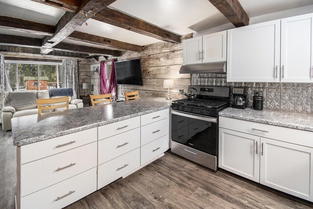 kitchen with under cabinet range hood, a peninsula, white cabinets, stainless steel range with gas cooktop, and dark wood finished floors