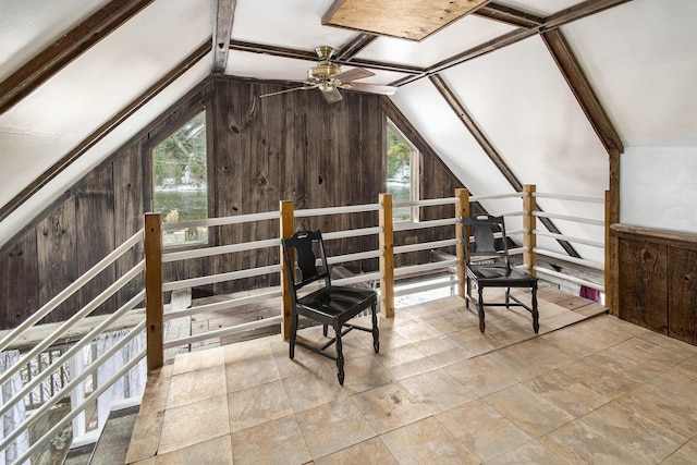 bonus room featuring wood walls, a ceiling fan, vaulted ceiling, and a wealth of natural light