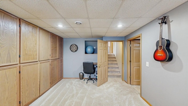 office space featuring recessed lighting, light carpet, a drop ceiling, and baseboards