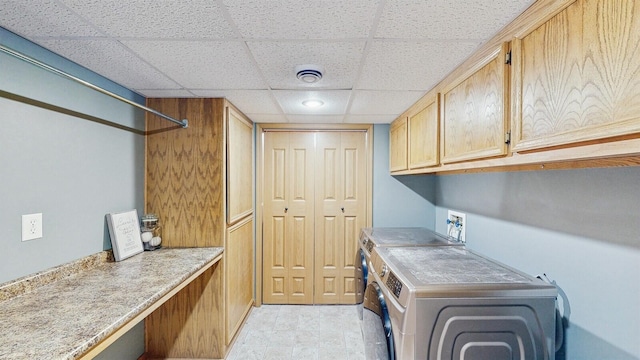 laundry area featuring separate washer and dryer and cabinet space