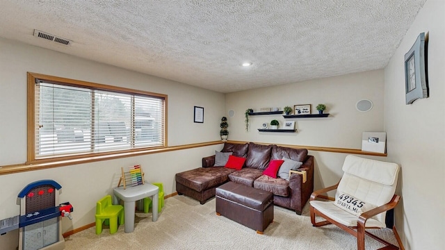 living room featuring a textured ceiling, carpet floors, visible vents, and baseboards