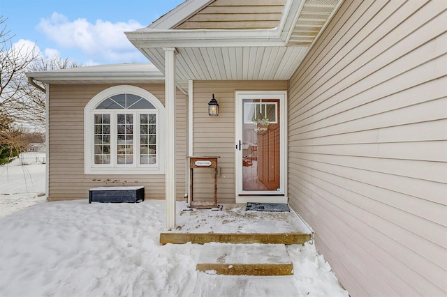 view of snow covered property entrance