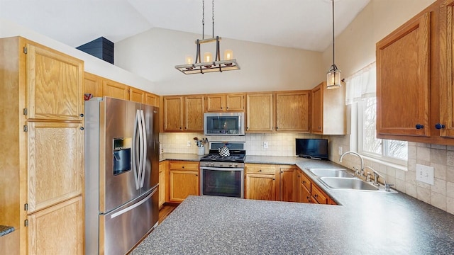 kitchen featuring hanging light fixtures, appliances with stainless steel finishes, a sink, and decorative backsplash