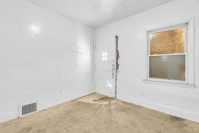 spare room with visible vents and unfinished concrete floors