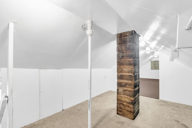 bonus room featuring lofted ceiling and carpet flooring