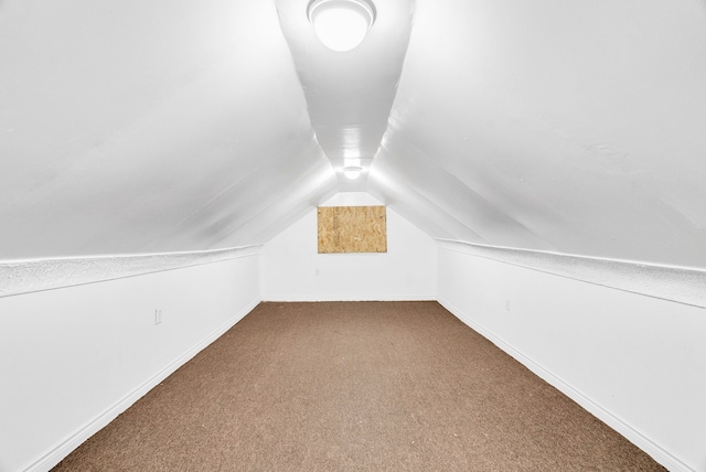 bonus room featuring carpet floors, baseboards, and lofted ceiling