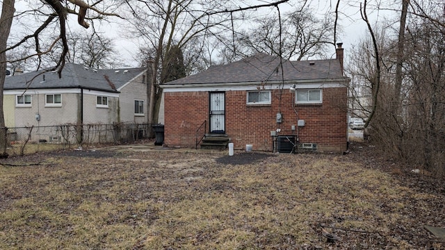 rear view of house featuring entry steps, central AC unit, a chimney, crawl space, and brick siding