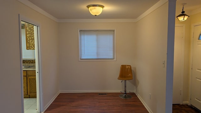 interior space featuring baseboards, visible vents, and wood finished floors