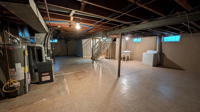 basement with heating unit, stairway, washer / clothes dryer, and gas water heater