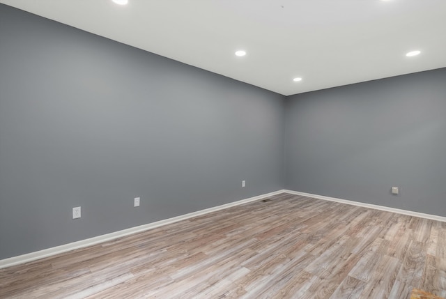 unfurnished room with recessed lighting, baseboards, and light wood finished floors