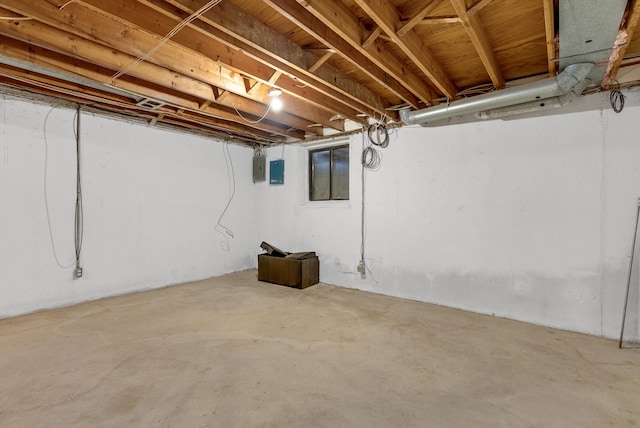 unfinished basement featuring electric panel