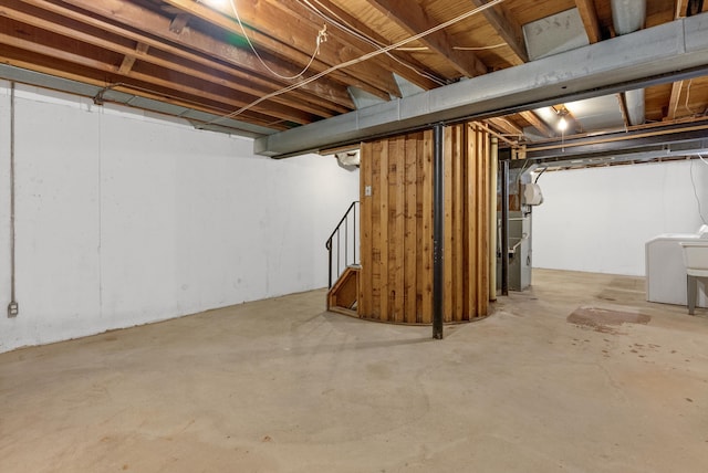 unfinished basement featuring heating unit and stairs