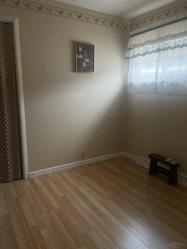 unfurnished room featuring light wood finished floors and baseboards