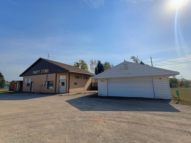 view of front of property featuring a garage and an outdoor structure