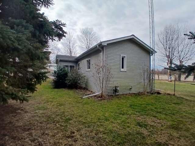 view of home's exterior with a yard