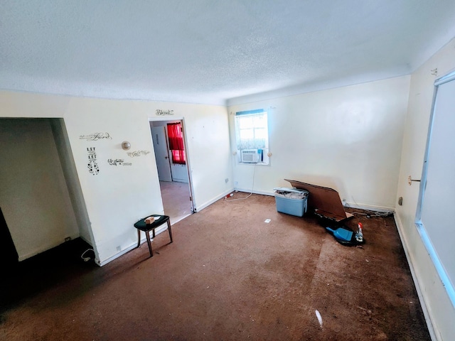 carpeted empty room featuring baseboards and a textured ceiling