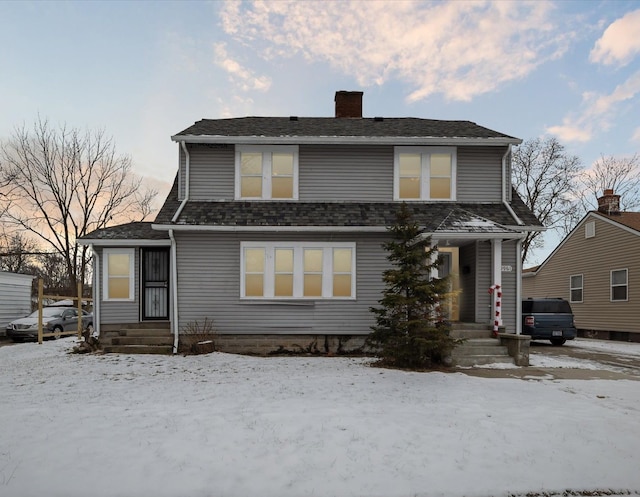 view of front of property featuring roof with shingles and a chimney