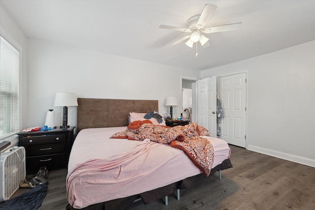 bedroom featuring wood finished floors, a ceiling fan, and baseboards