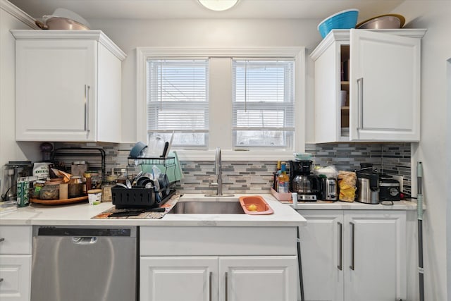 kitchen with white cabinetry, dishwasher, and a sink