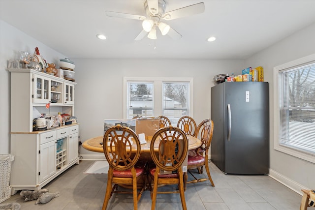 dining space with a wealth of natural light, ceiling fan, baseboards, and recessed lighting