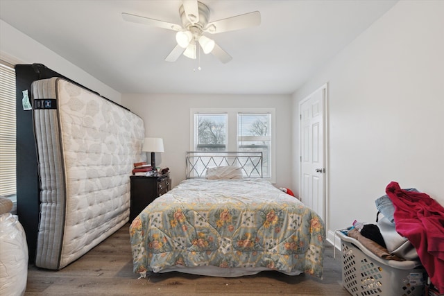 bedroom with a ceiling fan and wood finished floors