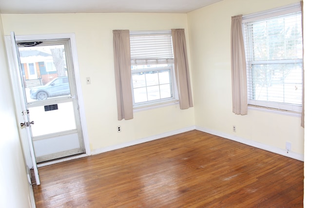 interior space featuring baseboards and wood finished floors