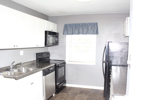 kitchen featuring baseboards, white cabinets, a sink, black appliances, and backsplash