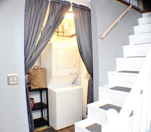 clothes washing area with laundry area and stacked washer / drying machine