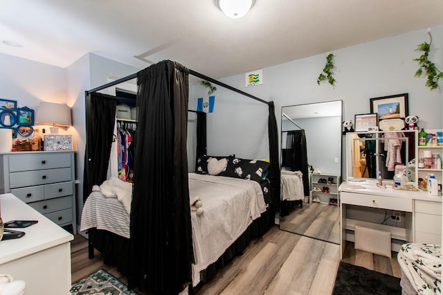 bedroom with a closet and light wood-type flooring