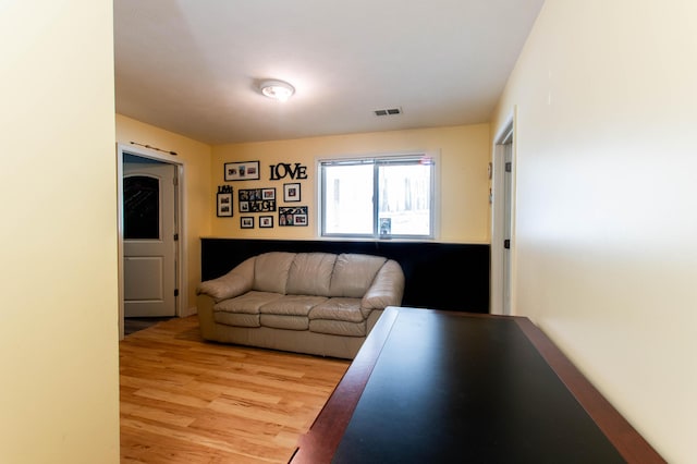 living area featuring light wood-style floors and visible vents