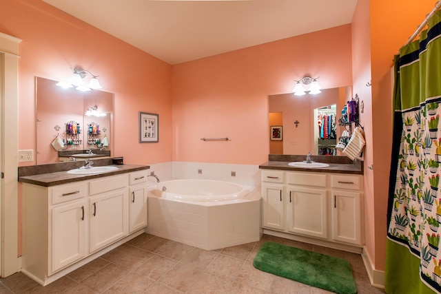 full bathroom with a garden tub, two vanities, and a sink