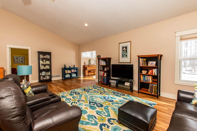 living room featuring lofted ceiling, recessed lighting, visible vents, wood finished floors, and baseboards