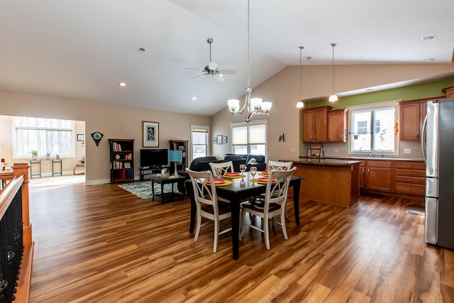 dining room featuring baseboards, wood finished floors, ceiling fan with notable chandelier, high vaulted ceiling, and recessed lighting