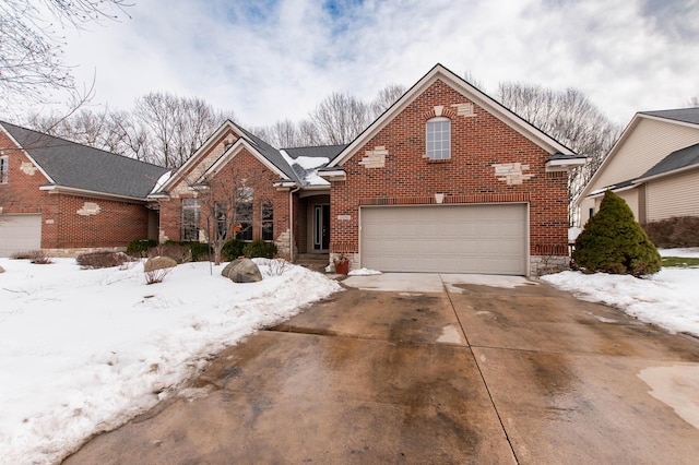 traditional home with a garage, brick siding, and driveway